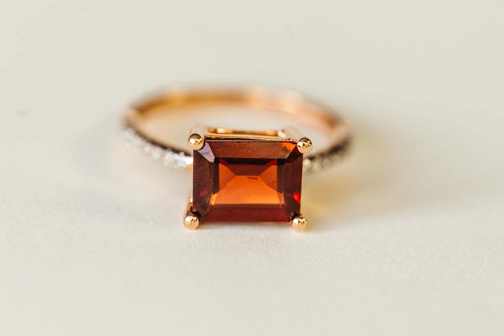 Ring with 9X7MM Emerald Cut Garnet and .12 Carat TW of Diamonds 14kt Rose Gold