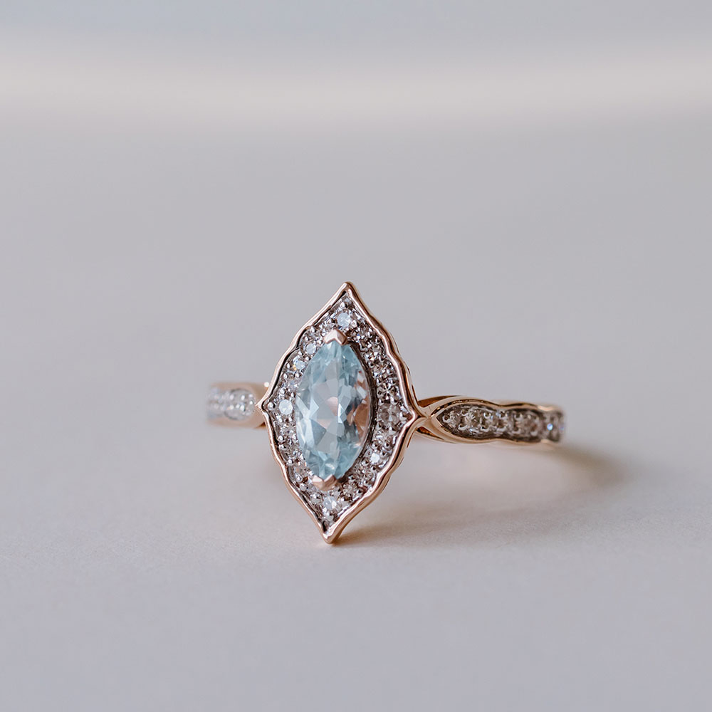 Halo Ring with 8X4MM Oval Aquamarine and .20 Carat TW of Diamonds in 14kt Rose Gold