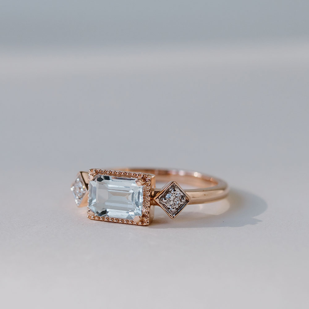 Ring with Emerald Cut Aquamarine and .08 Carat TW of Diamonds 14kt Rose Gold