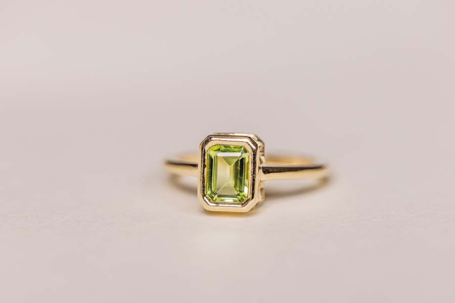 Ring with 7x5MM Emerald Cut Peridot 10kt Yellow Gold