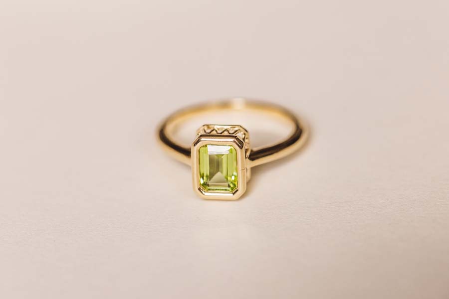 Ring with 7x5MM Emerald Cut Peridot in 10kt Yellow Gold