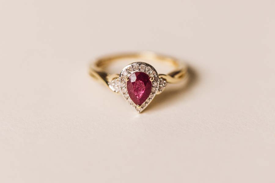 Halo Ring with .17 Carat TW of Diamonds and 7x5MM Pear Shape Ruby in 10kt Yellow Gold