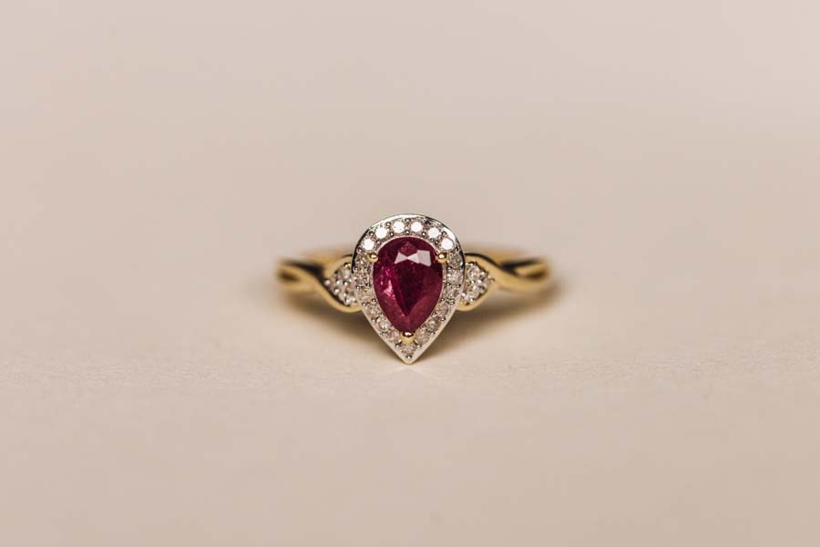 Halo Ring with .17 Carat TW of Diamonds and 7x5MM Pear Shape Ruby 10kt Yellow Gold