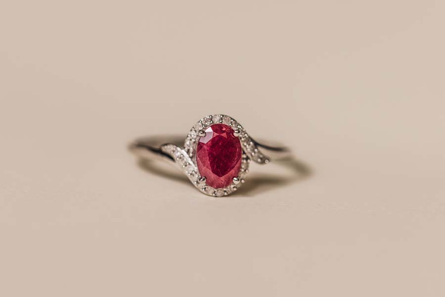 Halo Ring with .10 Carat TW of Diamonds and 7x5MM Oval Ruby in 10kt White Gold