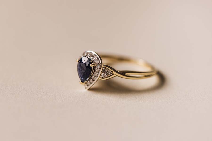 Halo Ring with .17 Carat TW of Diamonds and 7x5MM Pear Shape Blue Sapphire 10kt Yellow Gold