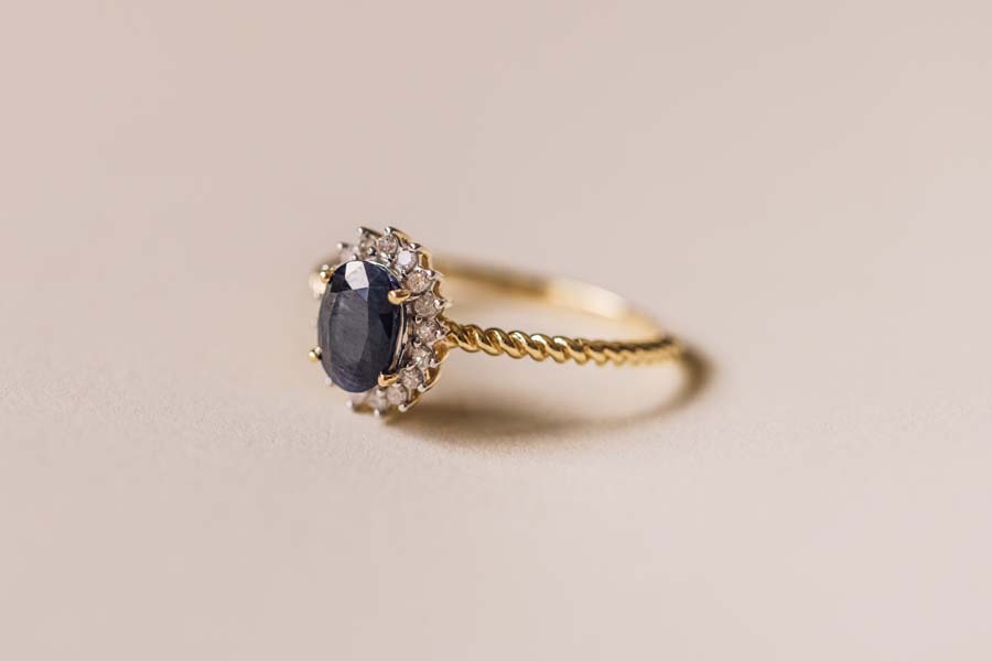 Halo Ring with .13 Carat TW of Diamonds and 7x5MM Oval Blue Sapphire 10kt Yellow Gold