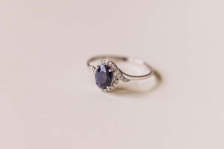 Halo Ring with .10 Carat TW of Diamonds and 7x5MM Oval Blue Sapphire in 10kt White Gold